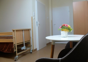 zdjęcie pokoju przedstawiające stolik, fotel i łóżko